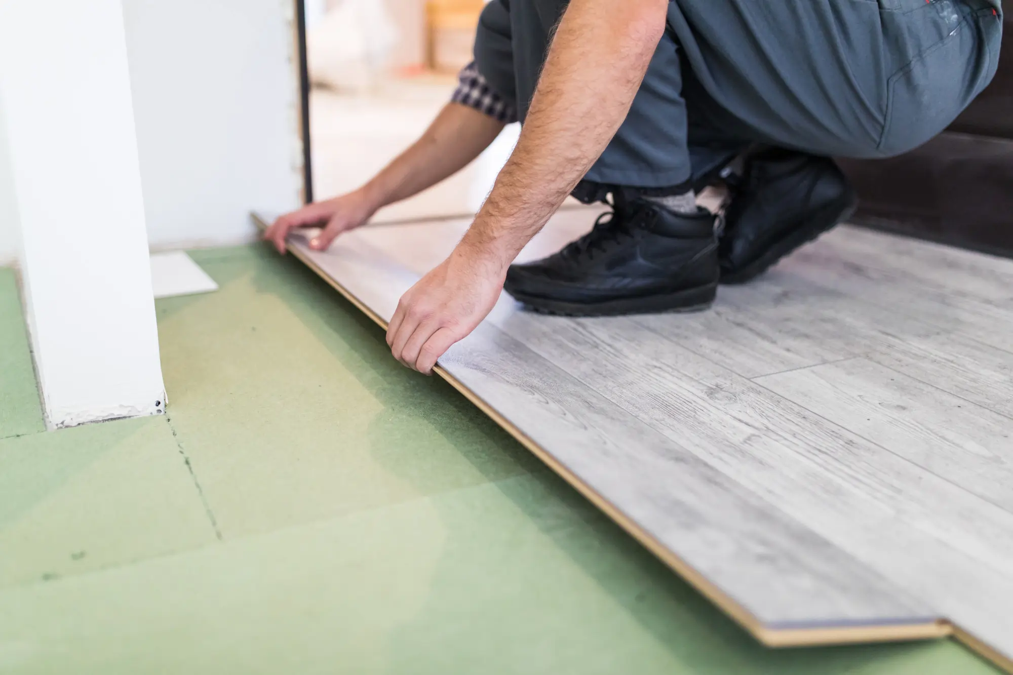People making a vinyl flooring installation.
